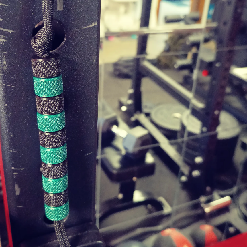 KnurlPearls rep counter mounted on a rack beside functional fitness equipment