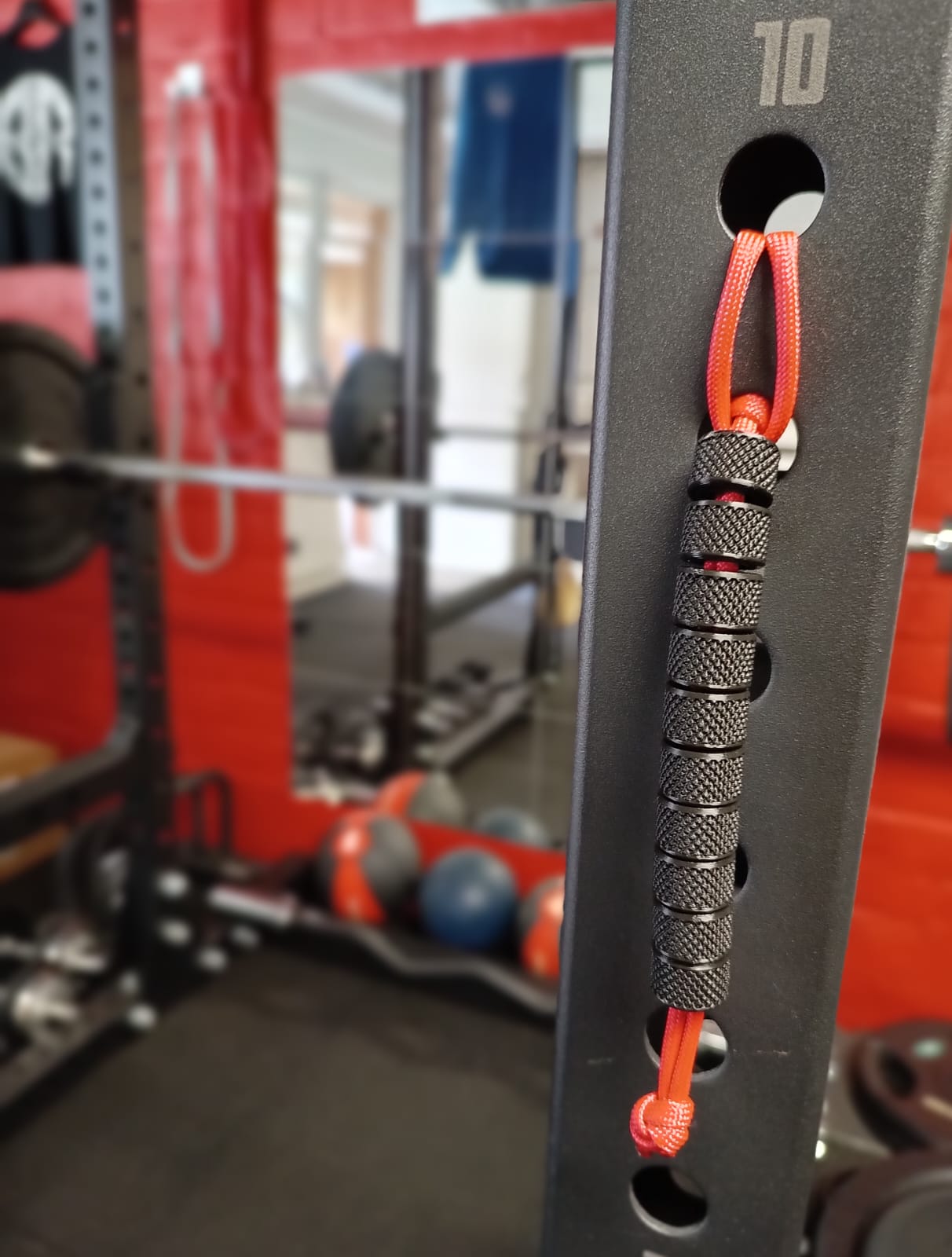 KnurlPearls rep counter attached vertically to a training rack
